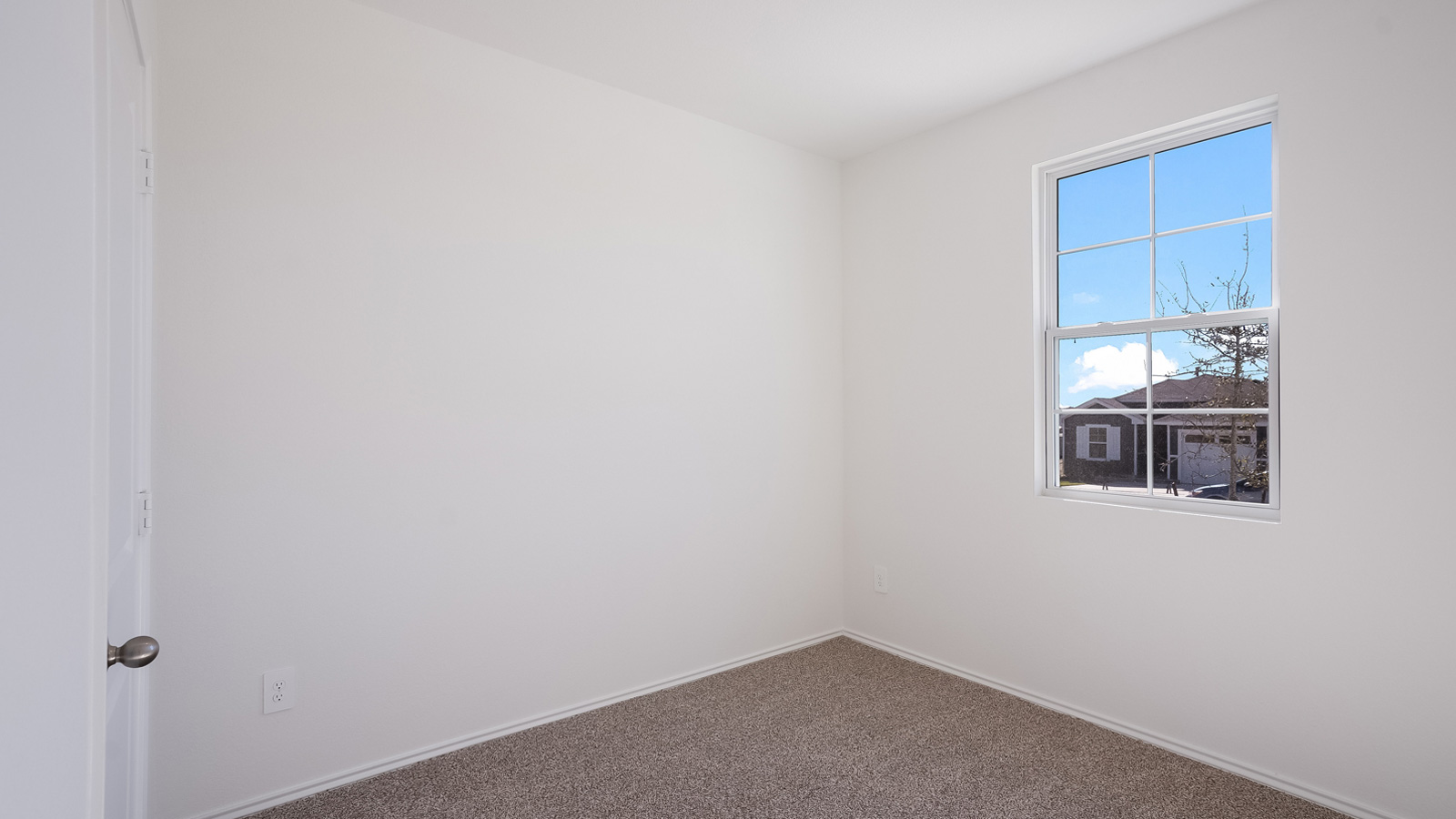 Bedroom 3 with carpeted floors.