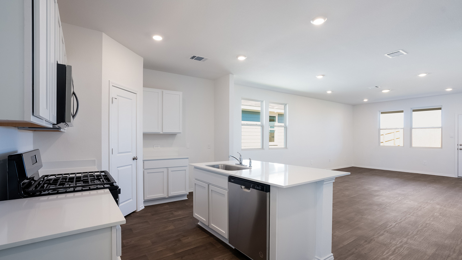 Gourmet kitchen with quartz countertops and stainless steel appliances.