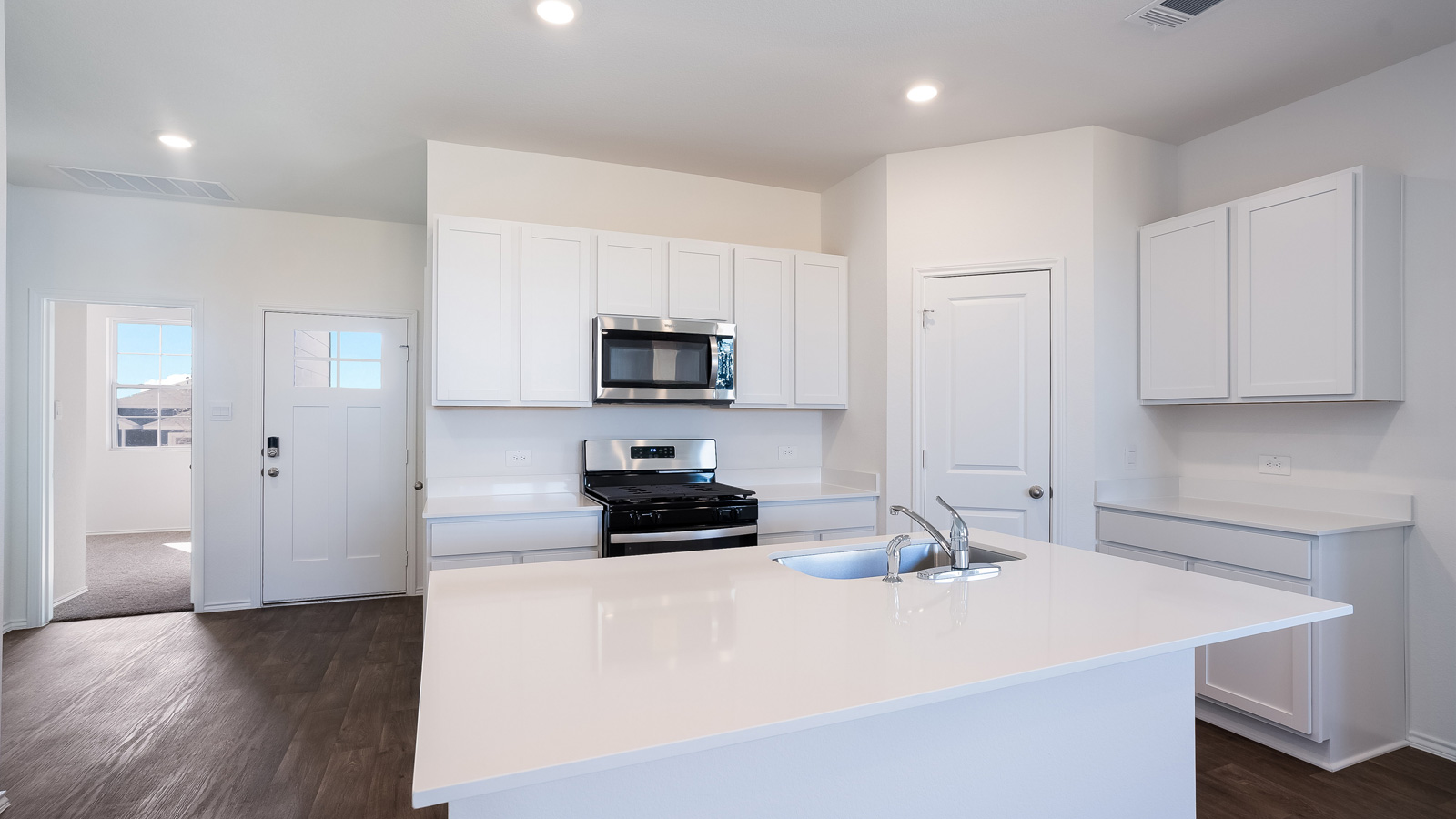 Large kitchen island with single undermount sink.