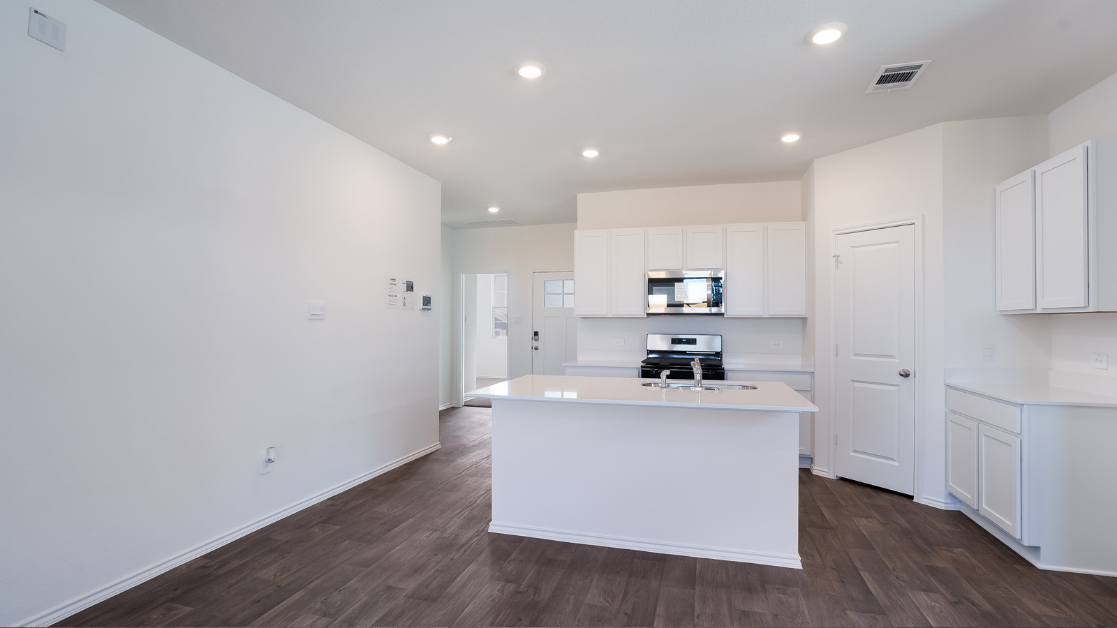 Gourmet kitchen with quartz countertops and stainless steel appliances.