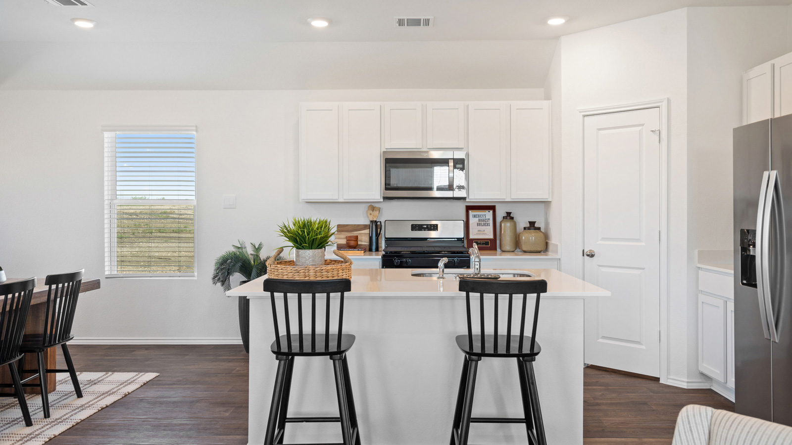 Kitchen with stainless steel appliances and quartz countertops.