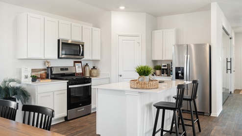 Gorgeous kitchen with stainless steel appliances.