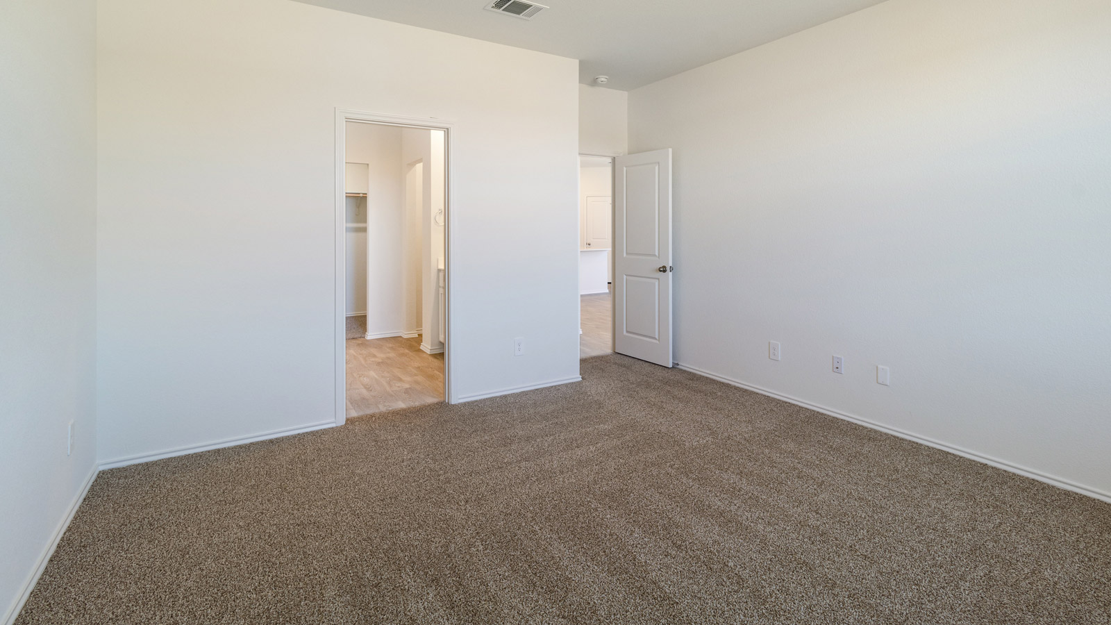 Bedroom 1 with carpeted flooring.