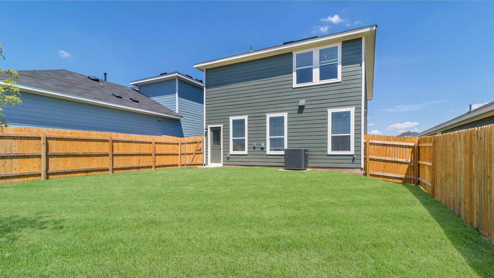 Backyard with open grassy space ready for outdoor relaxation and activities