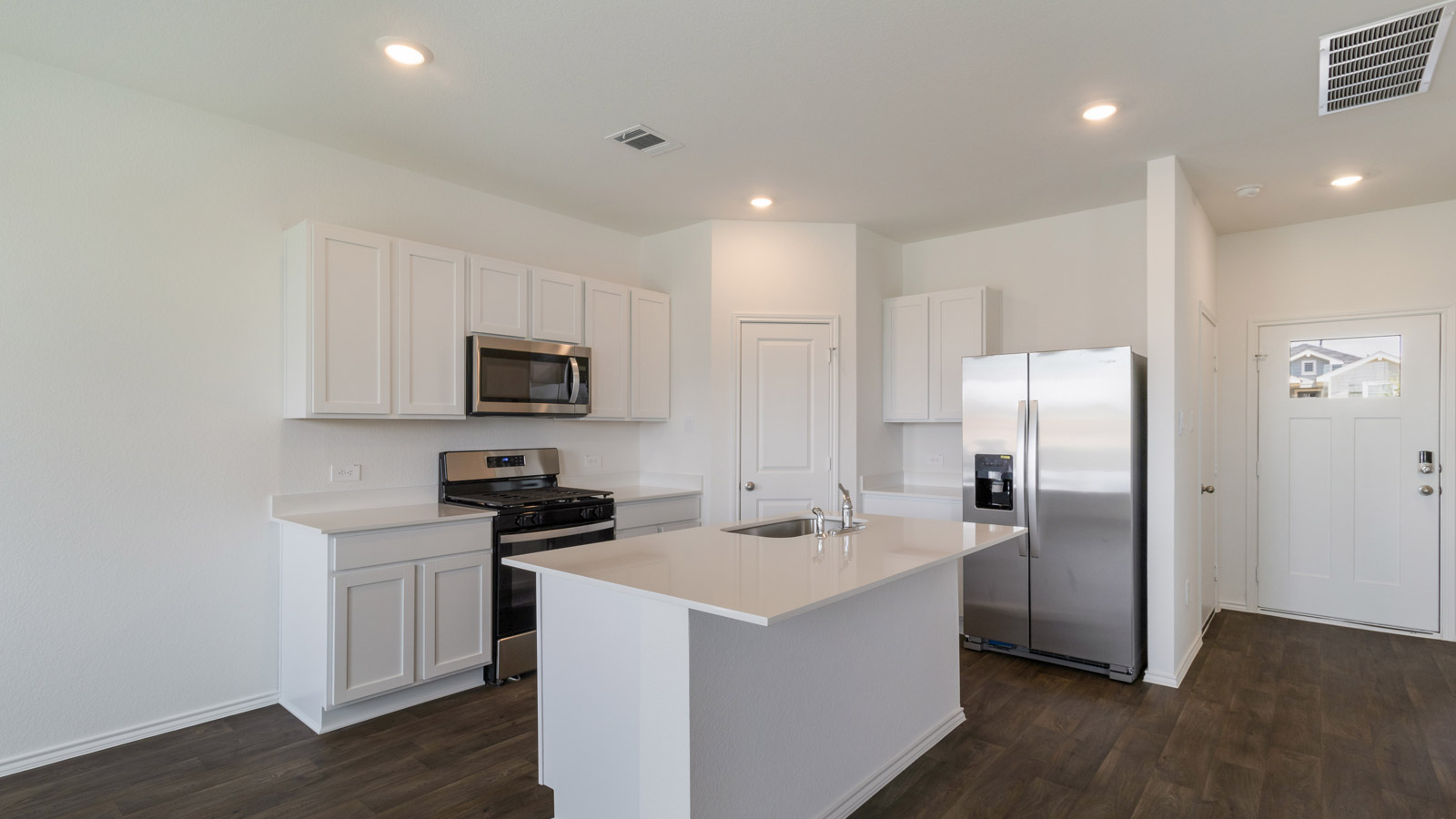Kitchen featuring cabinetry, prep zones, and open flow to dining and living areas