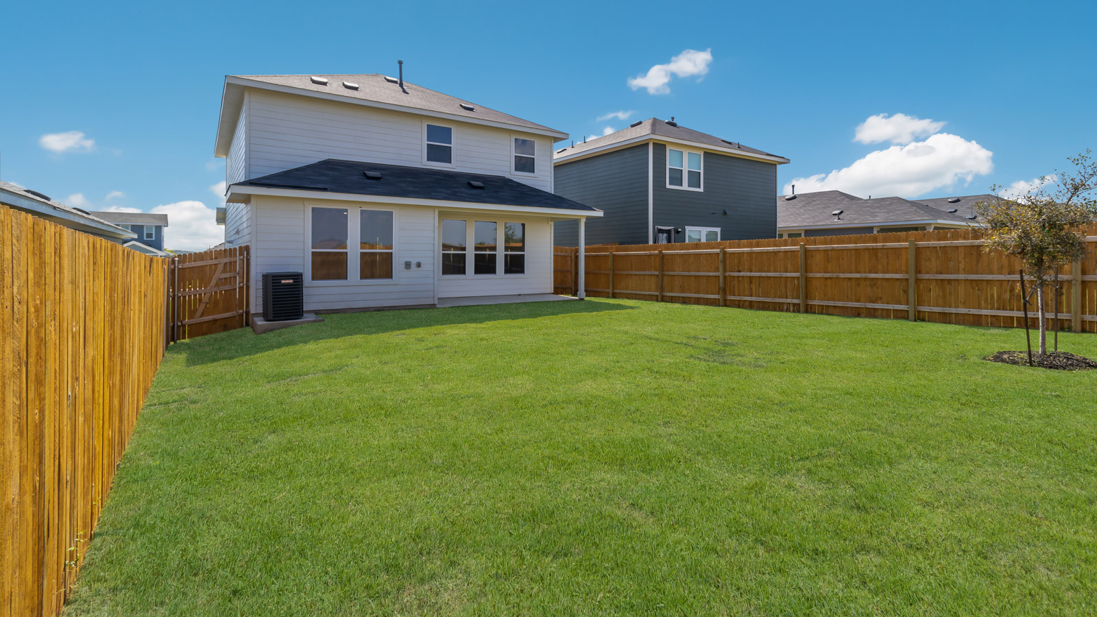 Backyard featuring covered paved patio ideal for seating, grilling, and outdoor relaxation