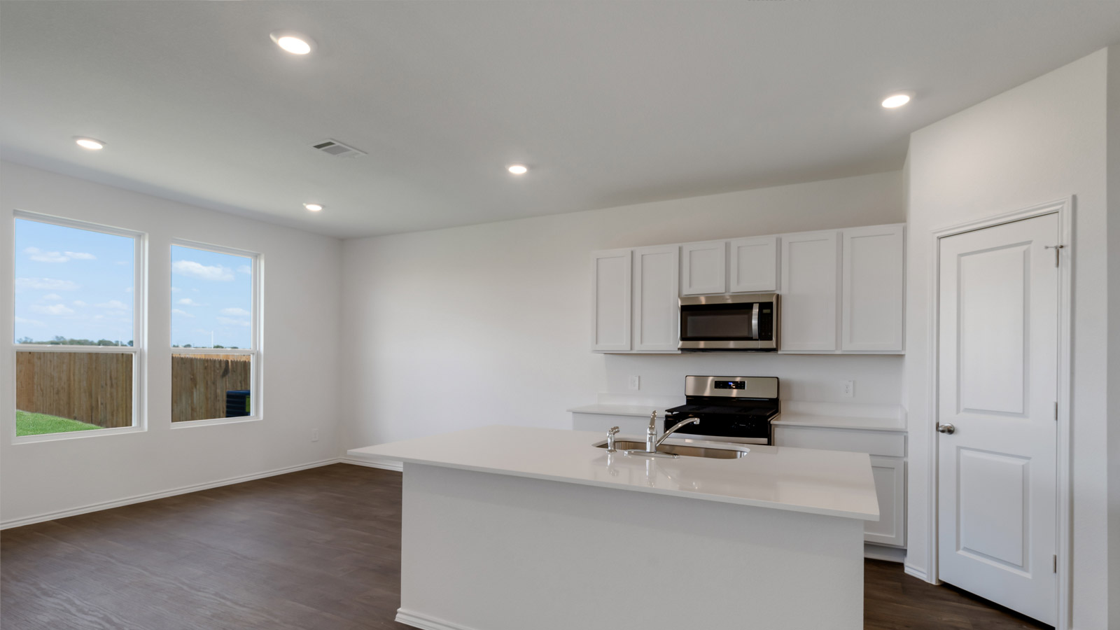 Kitchen layout with cabinetry, prep areas, and open design connecting to dining and living spaces