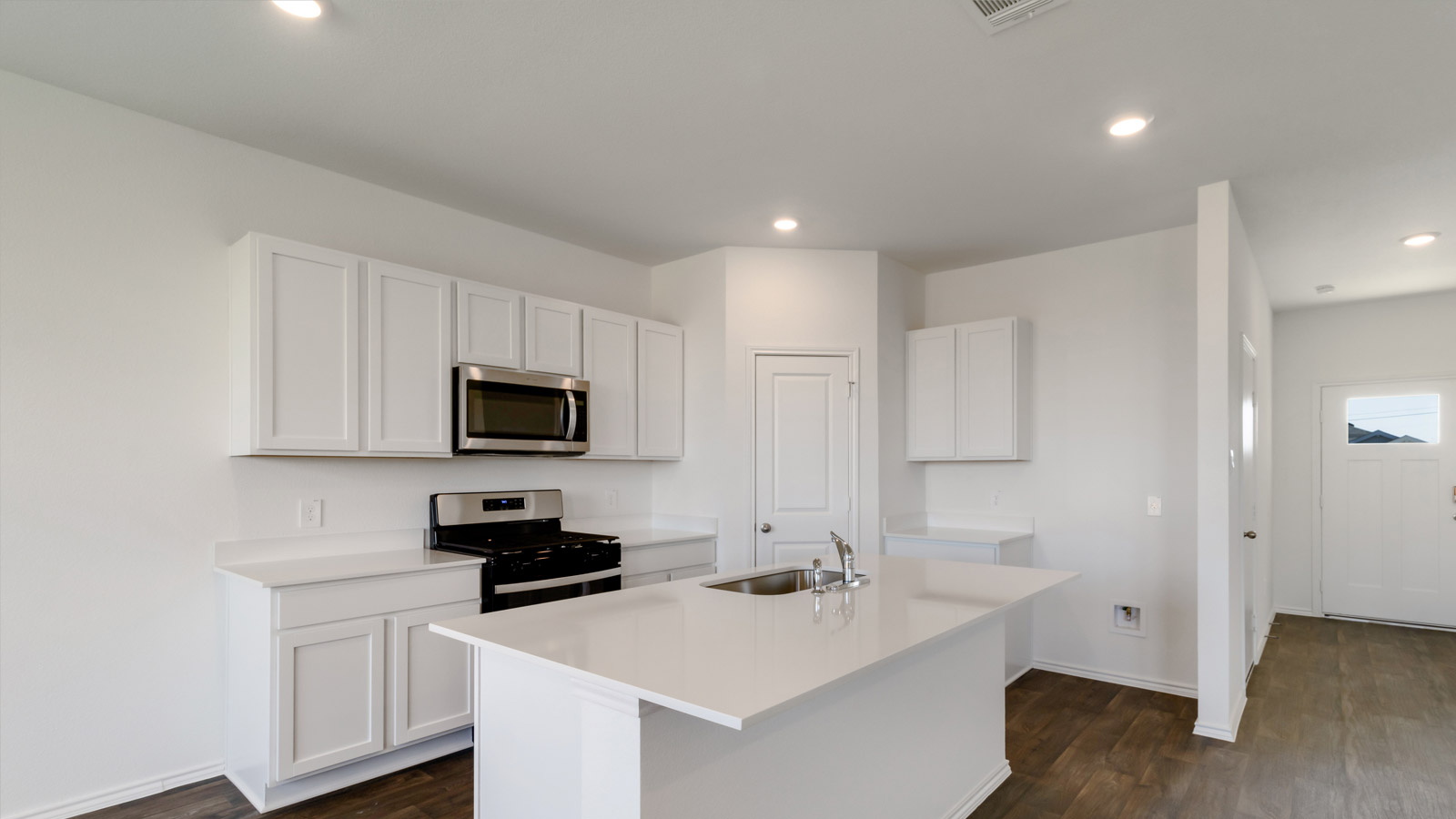 Kitchen island with sink, seating, and multi-prep zones anchoring the main floor Marigold by D.R. Horton