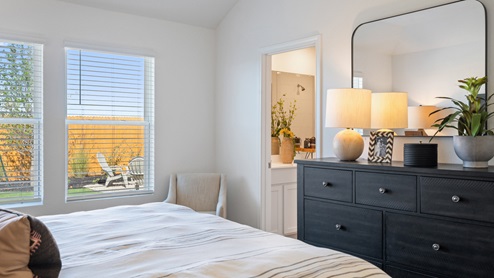The main bedroom, bedroom 1, with large windows and carpeted floors.
