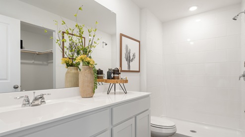 Adjoined ensuite with single vanity sink and walk-in shower.