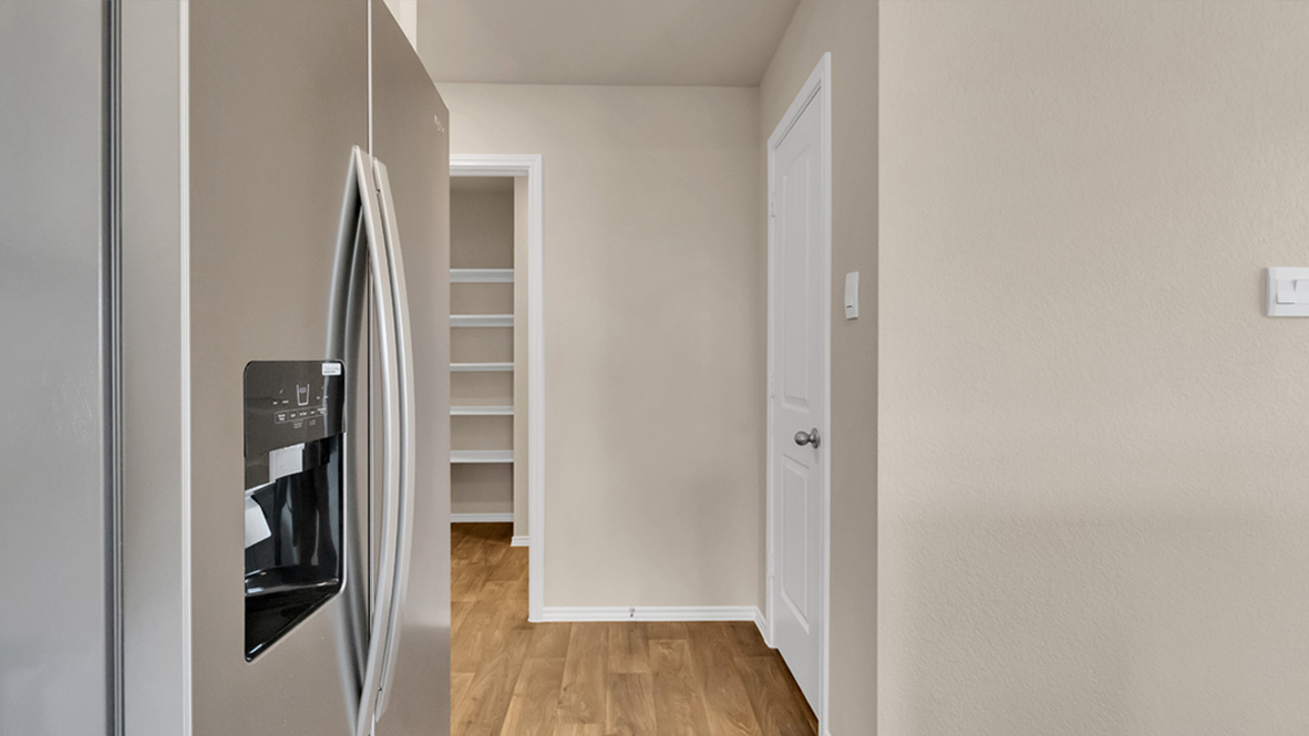spacious kitchen featuring a large island, white cabinetry and stainless steel appliances