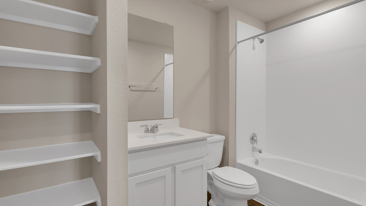 bathroom featuring a vanity sink, built in shelves, a toilet and a shower