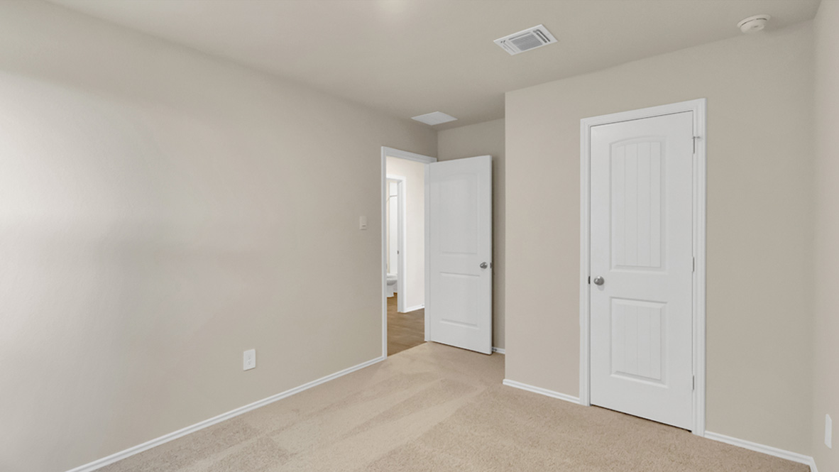 bedroom featuring beige carpet, beige walls and a window