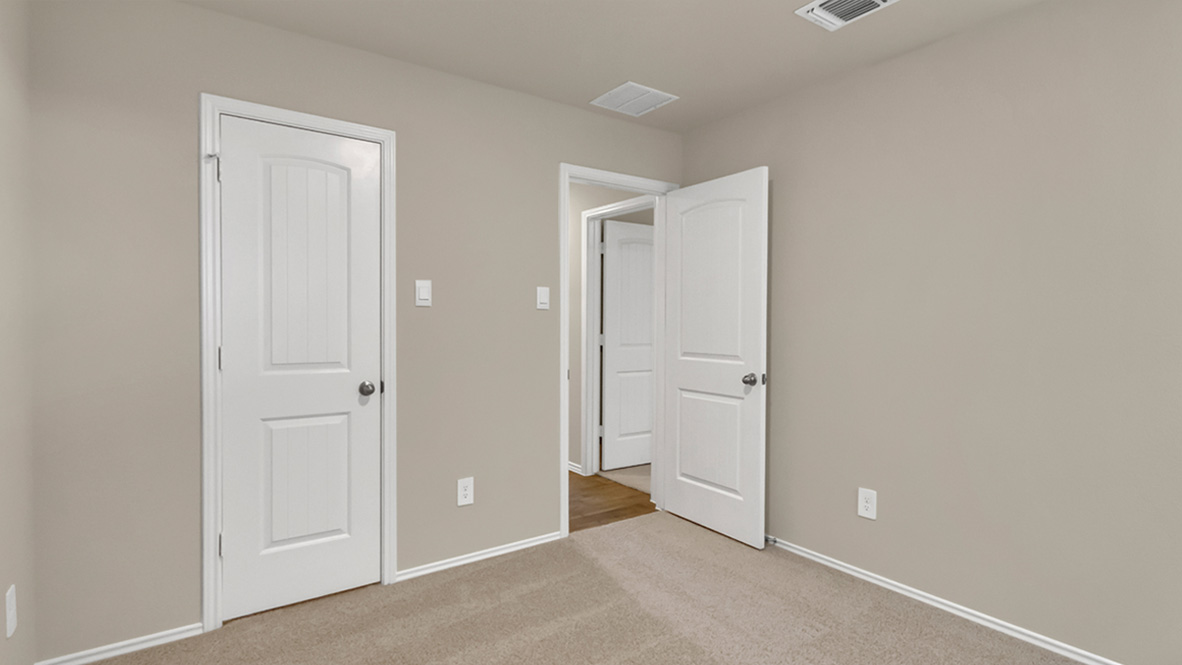 bedroom featuring beige carpet, beige walls and a window