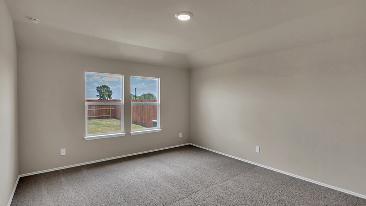 bedroom featuring beige carpet, beige walls and a window