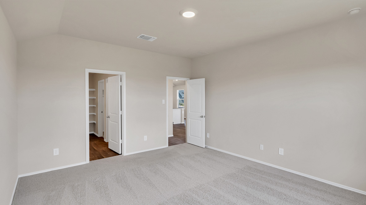 .bedroom featuring beige carpet, beige walls and a window