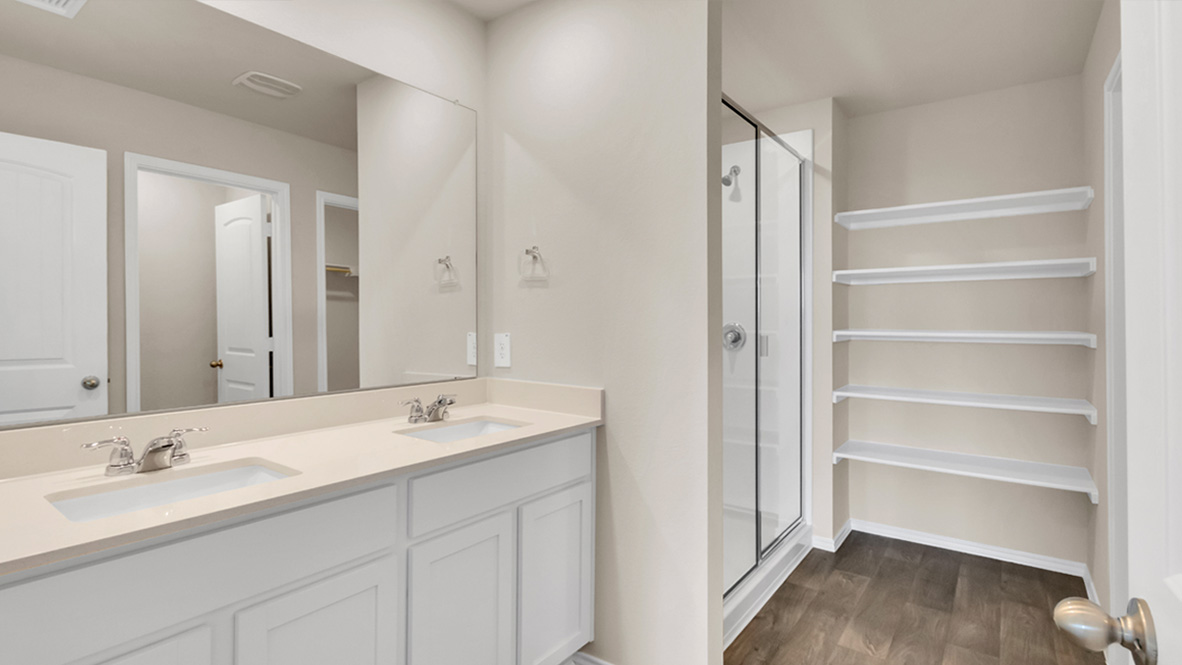 bathroom featuring dual vanity sinks, and built in shelves