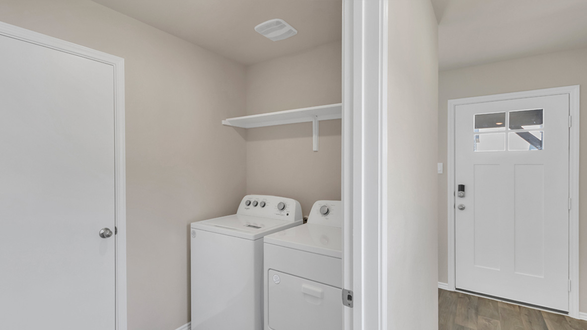 spacious laundry room featuring side by side washer and dryer