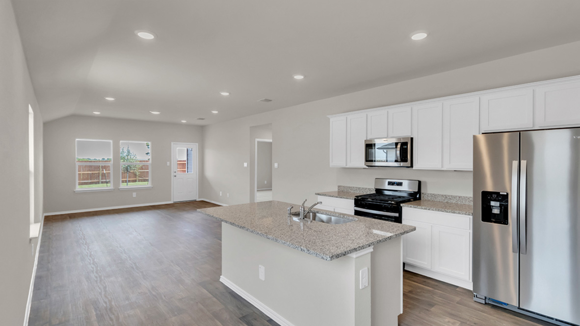 spacious kitchen featuring a large island, white cabinetry and stainless steel appliances