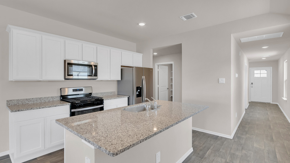spacious kitchen featuring a large island, white cabinetry and stainless steel appliances