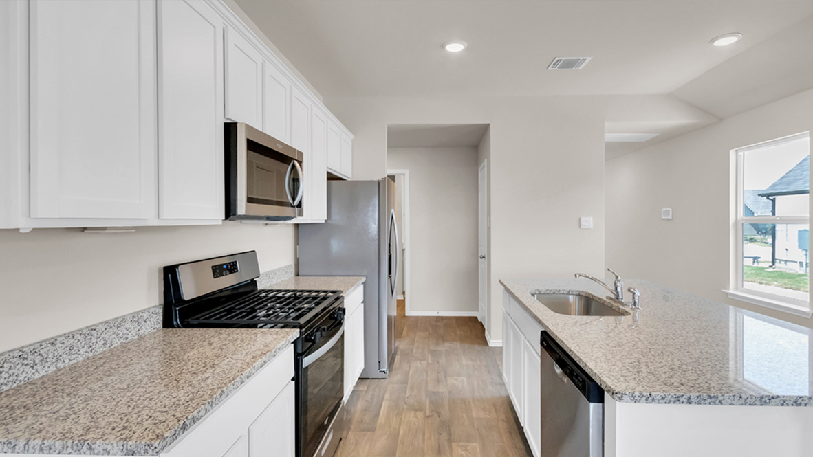 spacious kitchen featuring a large island, white cabinetry and stainless steel appliances