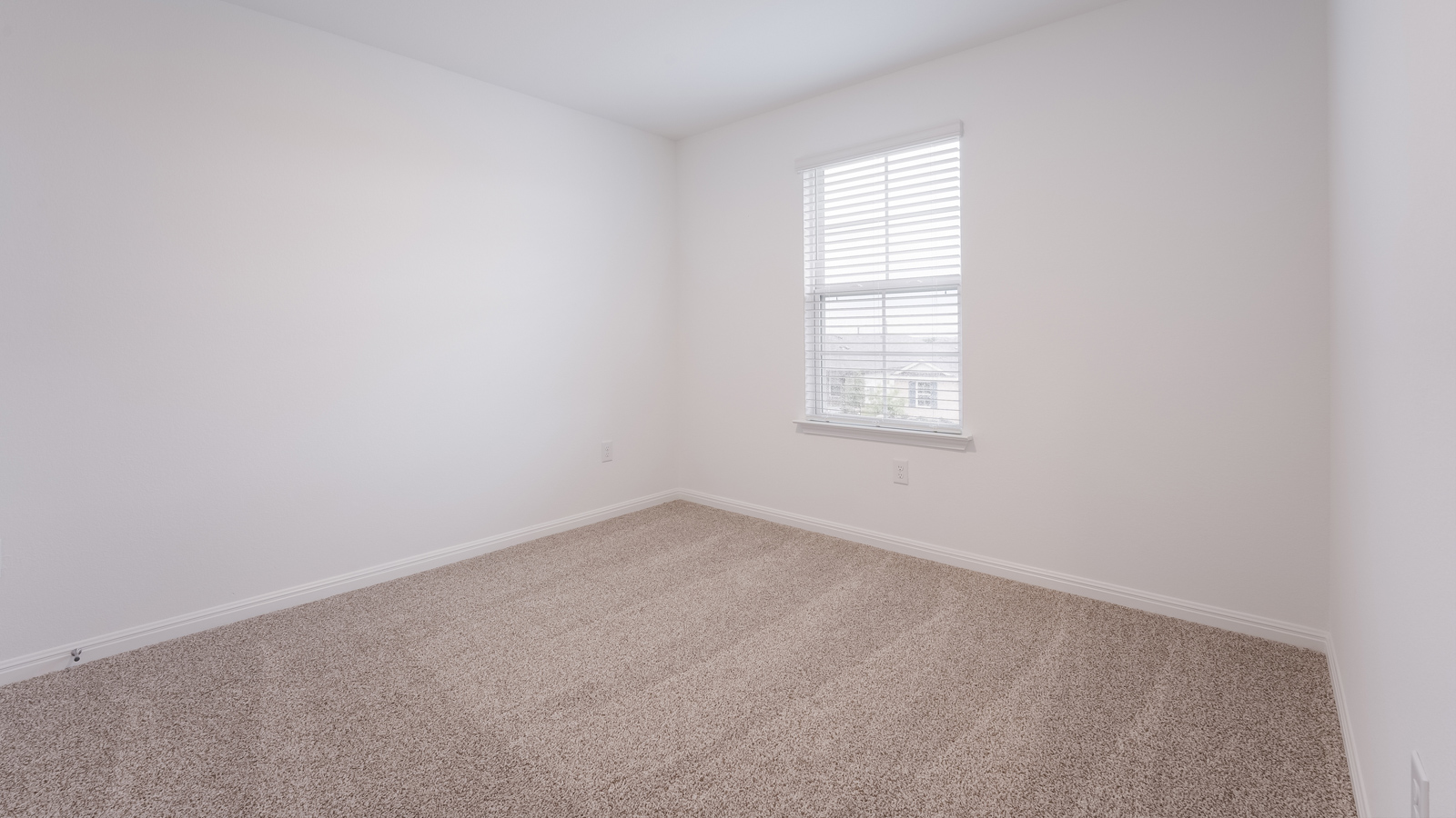 Bedroom 2 with carpeted floors and closet.