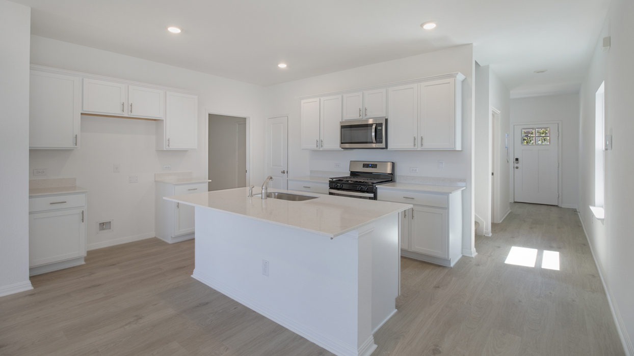 Kitchen featuring white cabinets, stainless steel appliances, and a large island.