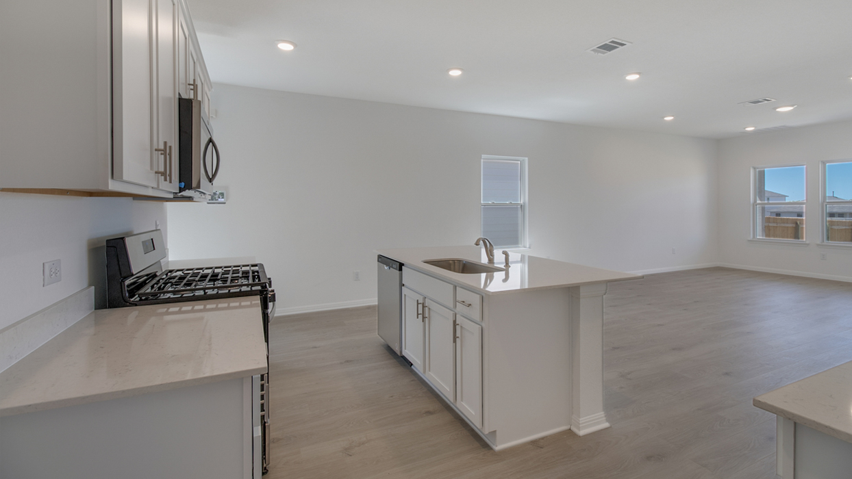 Kitchen featuring white cabinets, stainless steel appliances, and a large island.