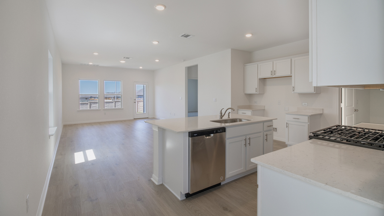 Kitchen featuring white cabinets, stainless steel appliances, and a large island.