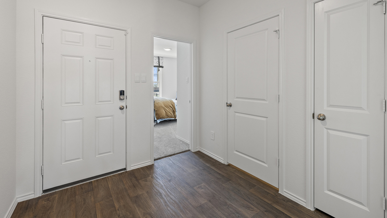 hallway view featuring white doors