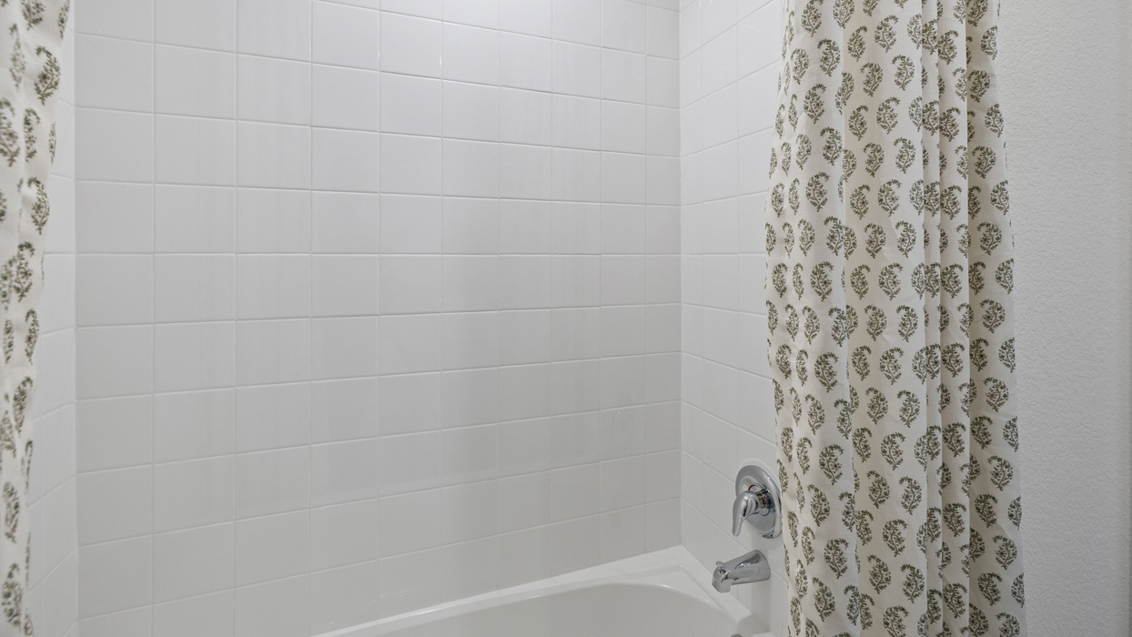 bathroom with a white tiled shower