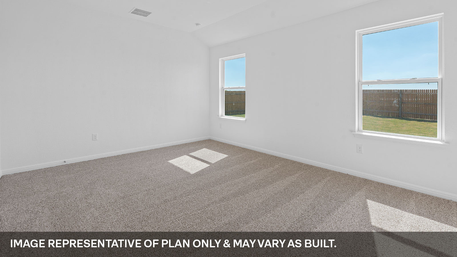 Primary bedroom with two windows.