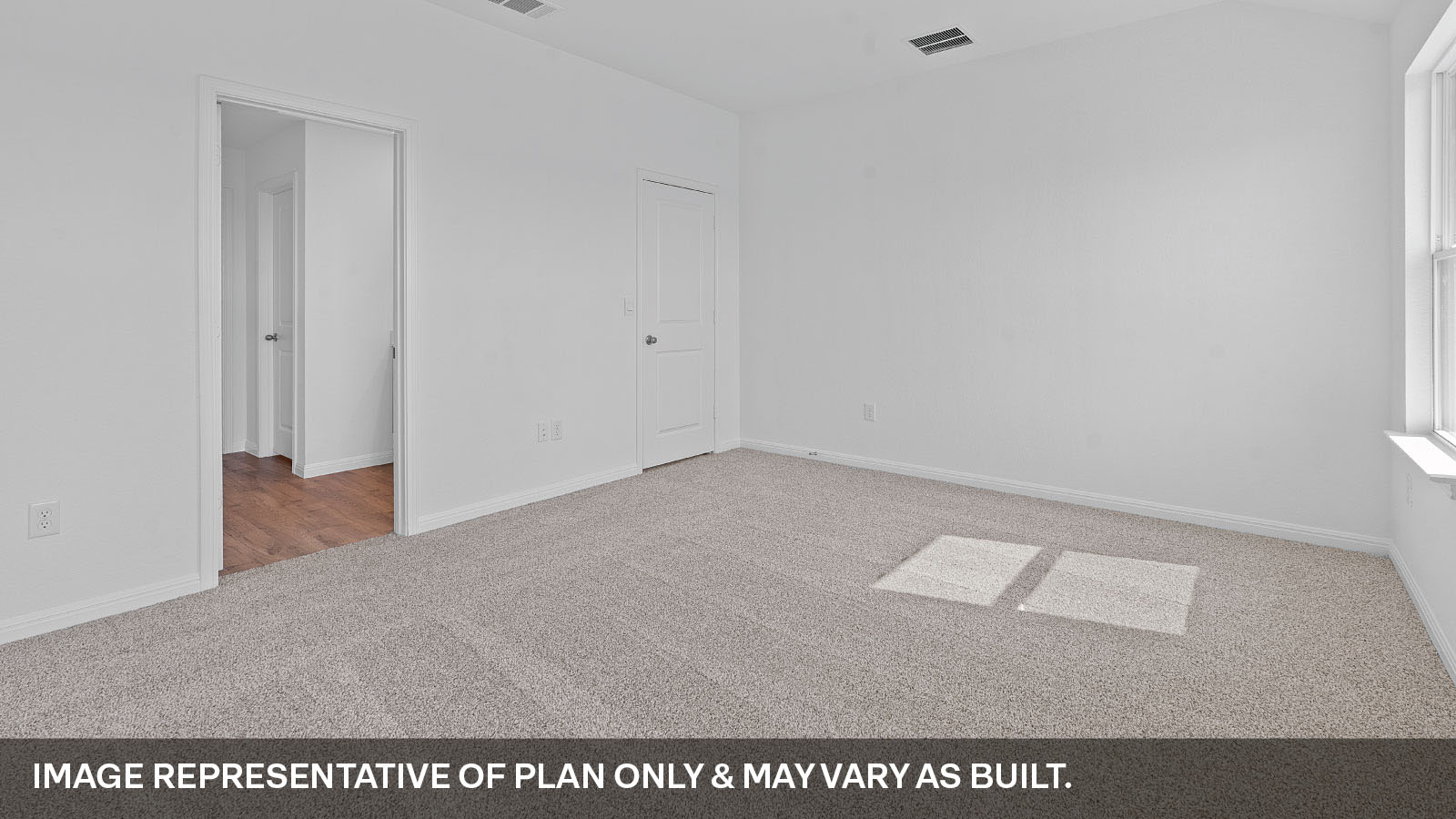 Primary bedroom with two windows.,