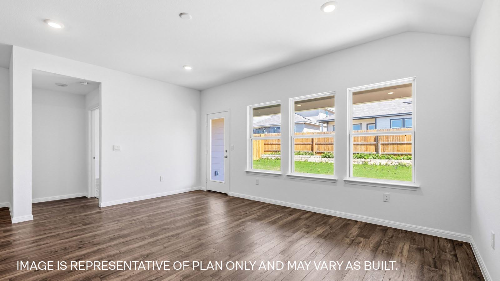 Open living area with three windows.