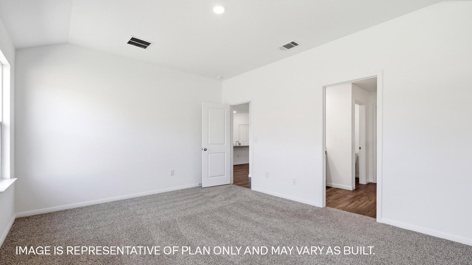 Bedroom 1 with carpeted flooring and two windows.