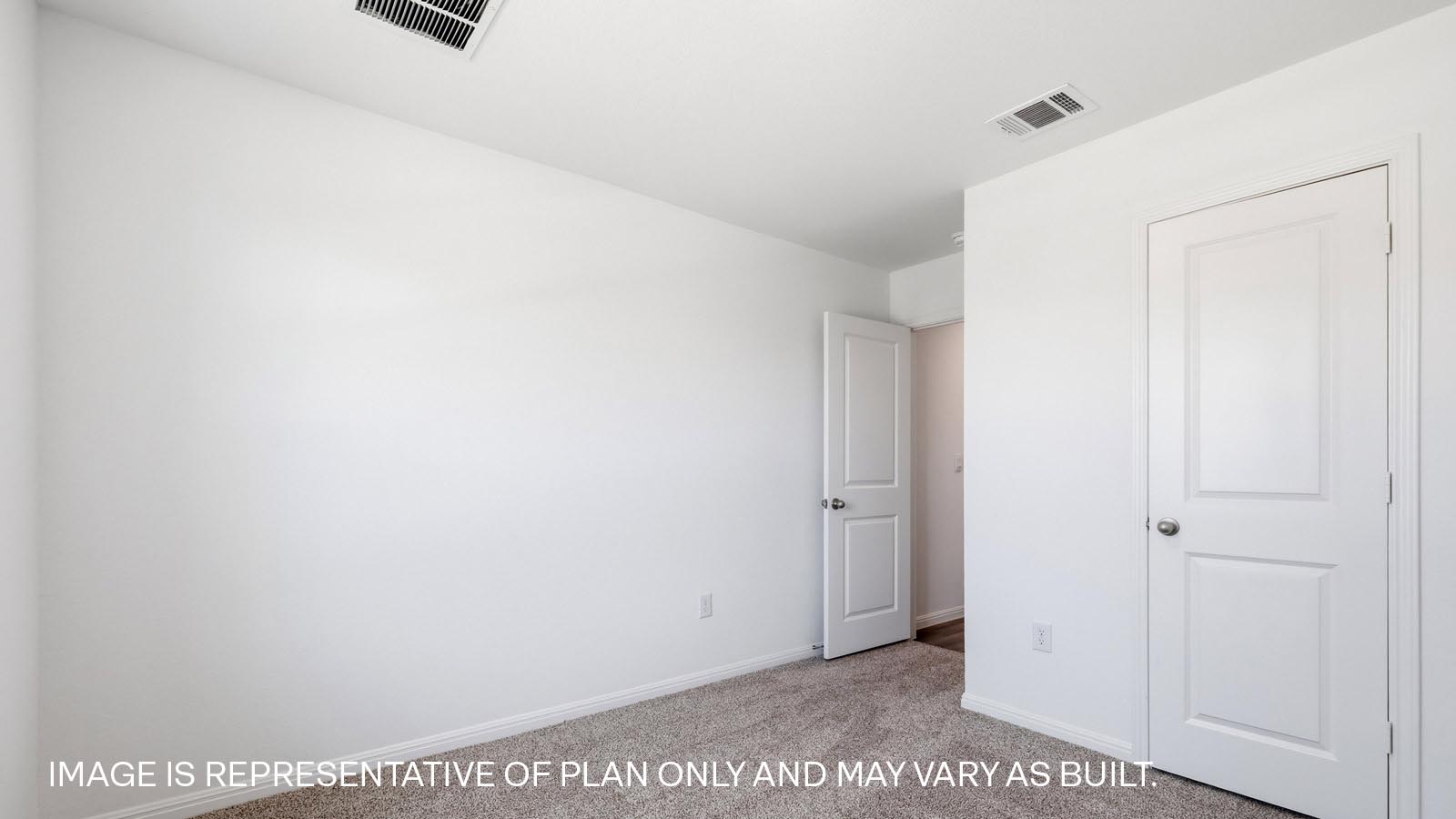 Bedroom 2 with carpeted flooring.