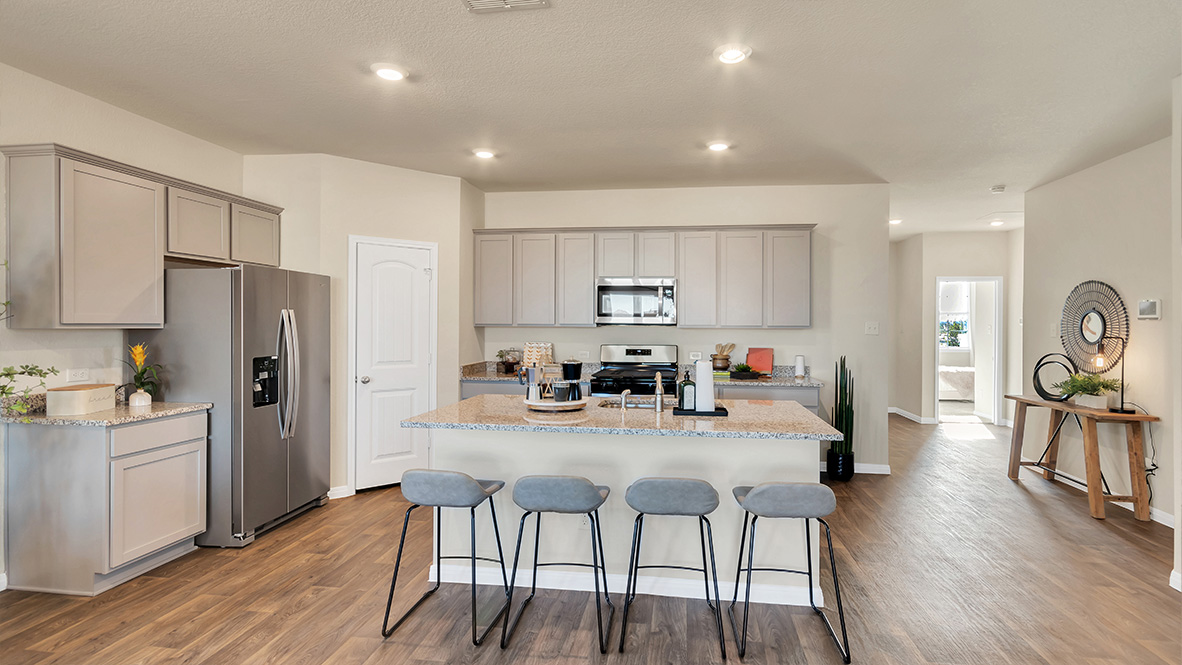 spacious kitchen featuring light grey cabinetry, large island and stainless steel appliances