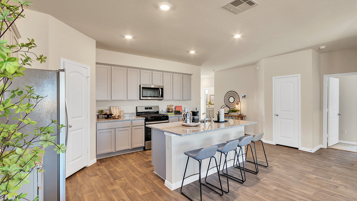 spacious kitchen featuring light grey cabinetry, large island and stainless steel appliances