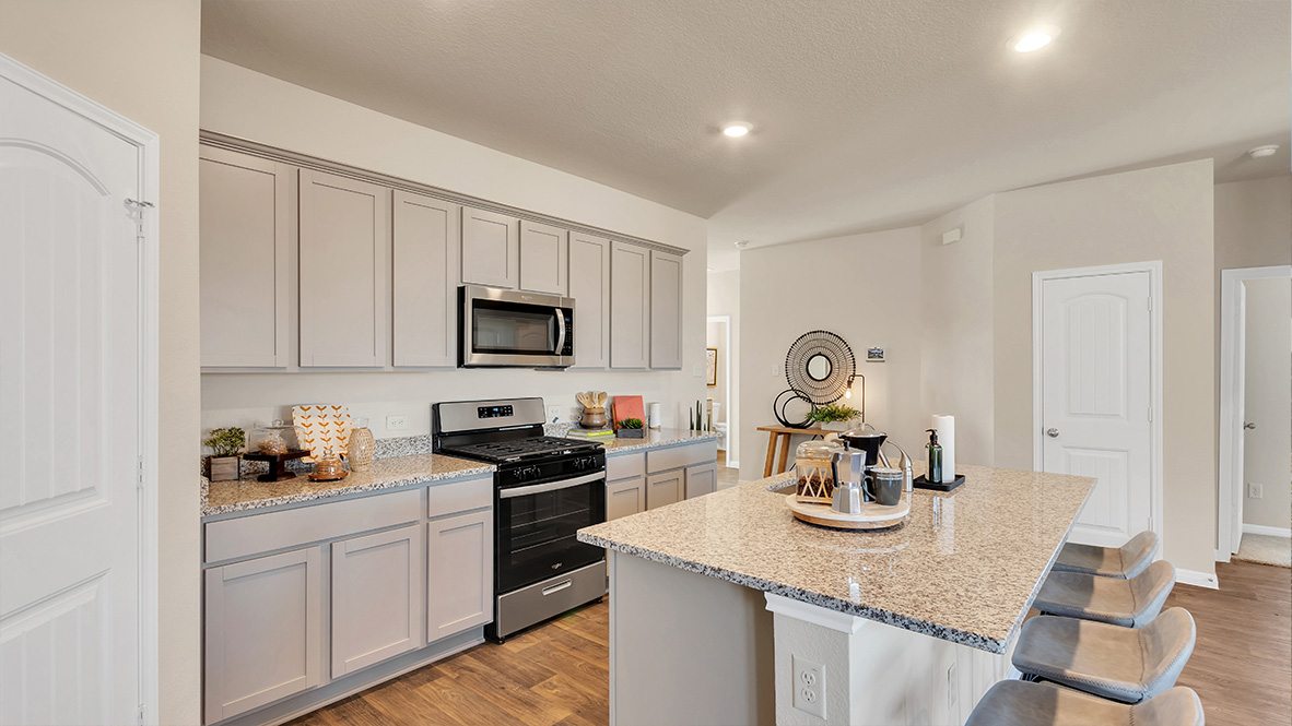 spacious kitchen featuring light grey cabinetry, large island and stainless steel appliances