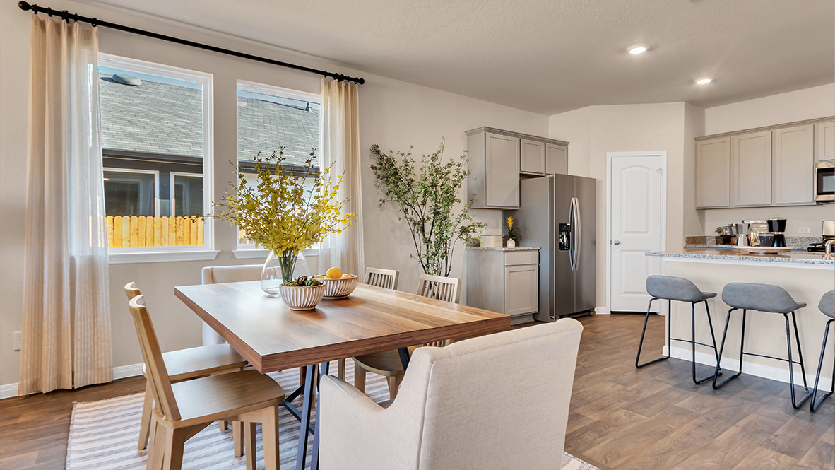 dining room off of the kitchen featuring rectangular table with 6 chairs surrounding