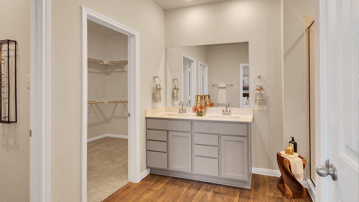 bathroom featuring dual vanity sinks, and a walk in shower