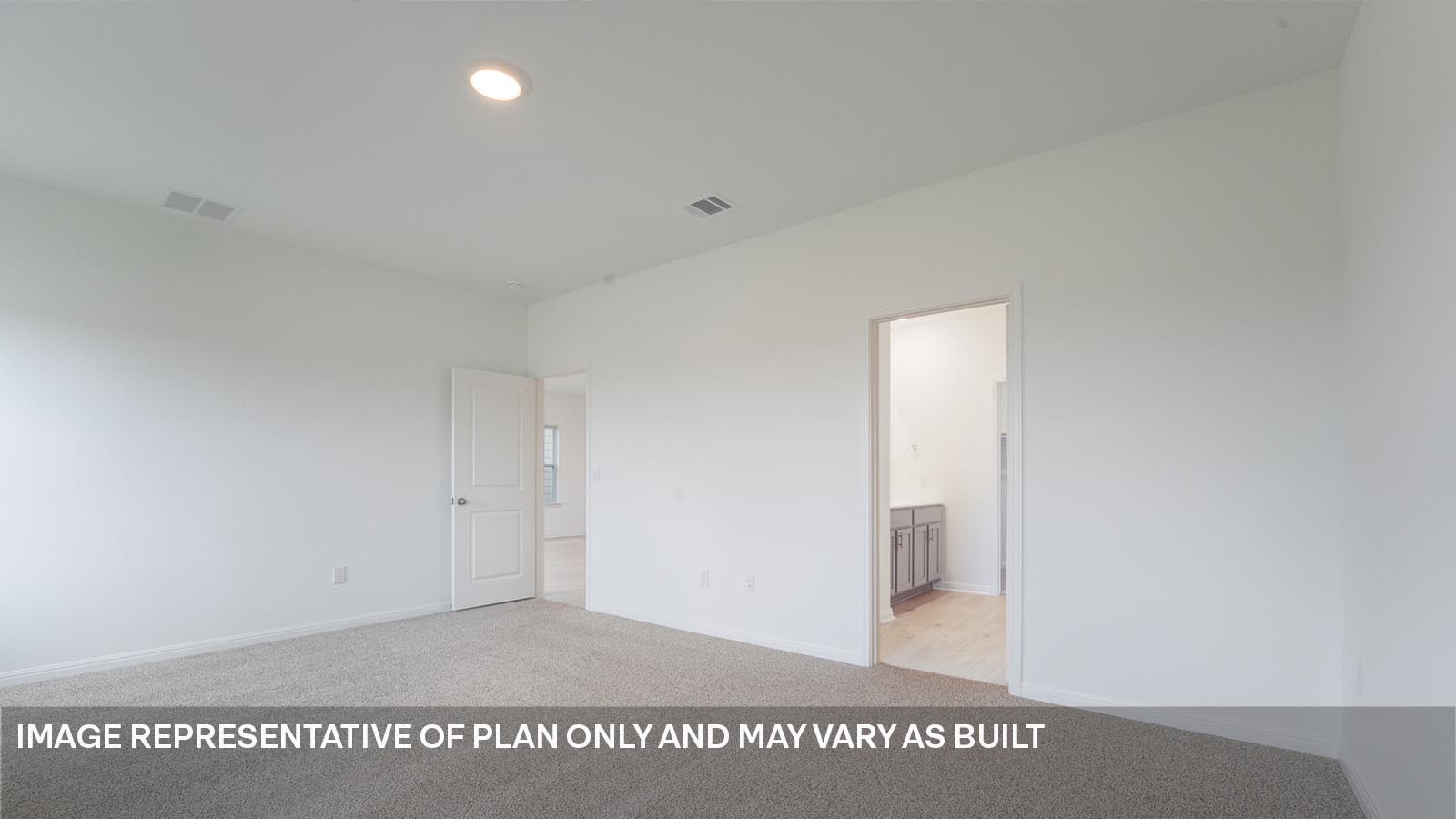 Primary bedroom with carpeted flooring, two windows. and ensuite bathroom.