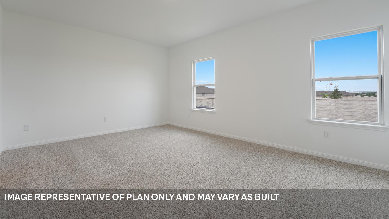 Primary bedroom with carpeted flooring and two windows.