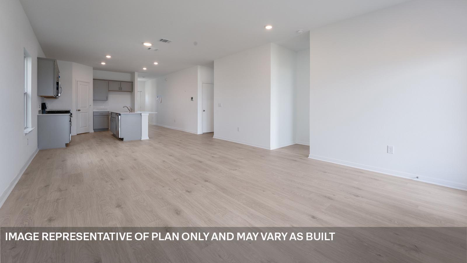 Open living area with laminated wood flooring.