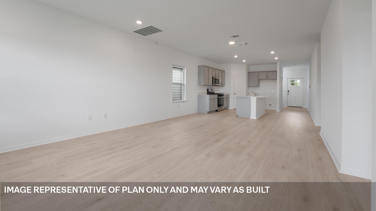 Open living area with laminated wood flooring.