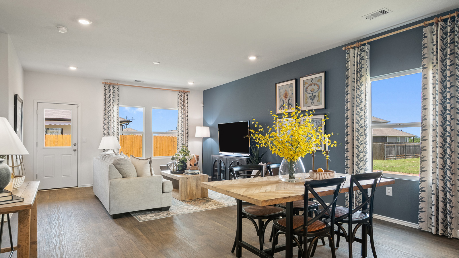 Open concept dining area with simple furnishings connecting to the living area.