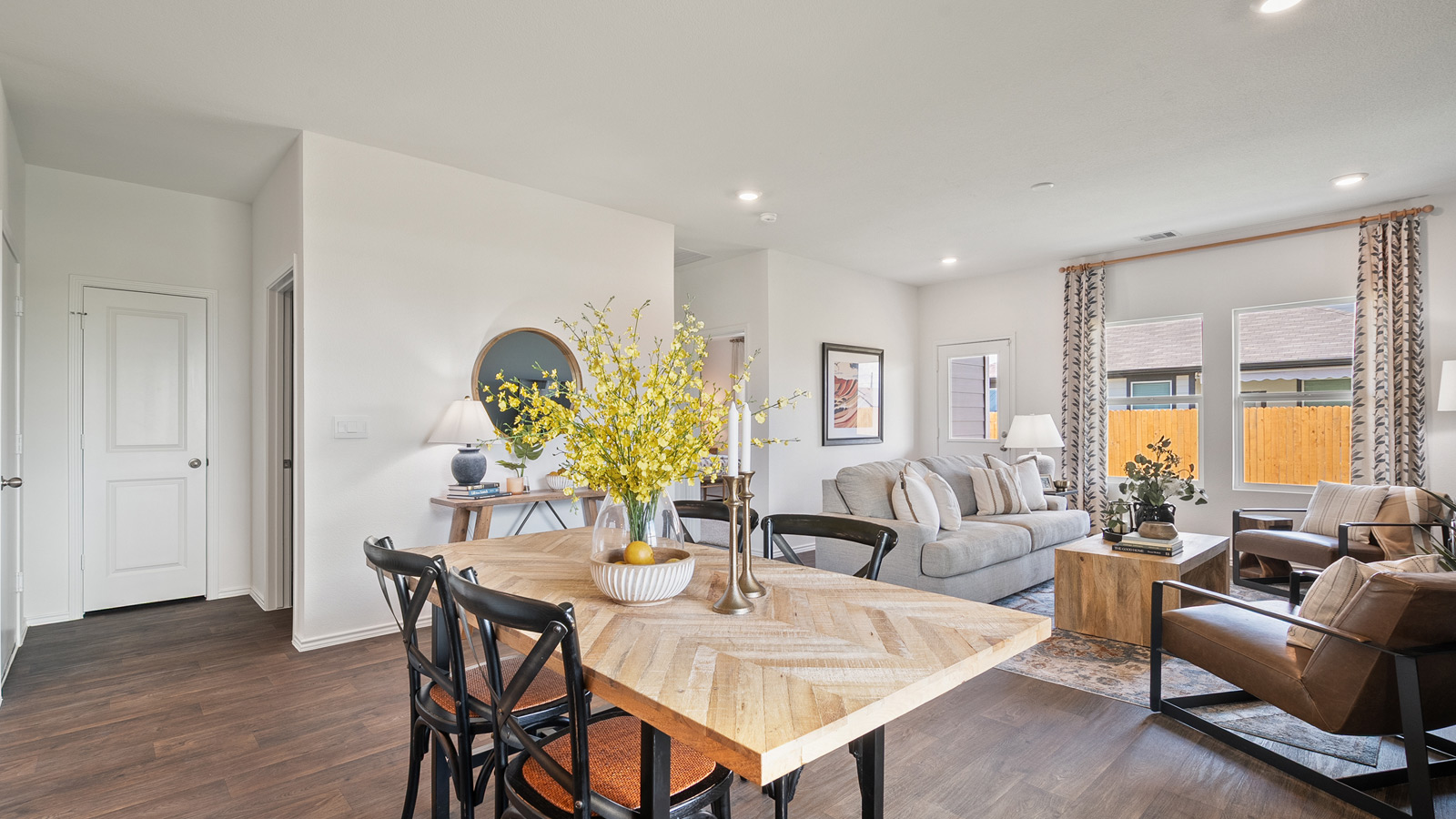 Open concept dining area with simple furnishings connecting to the living area.