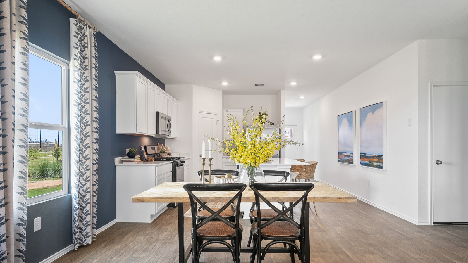 Open concept dining area with simple furnishings and a window