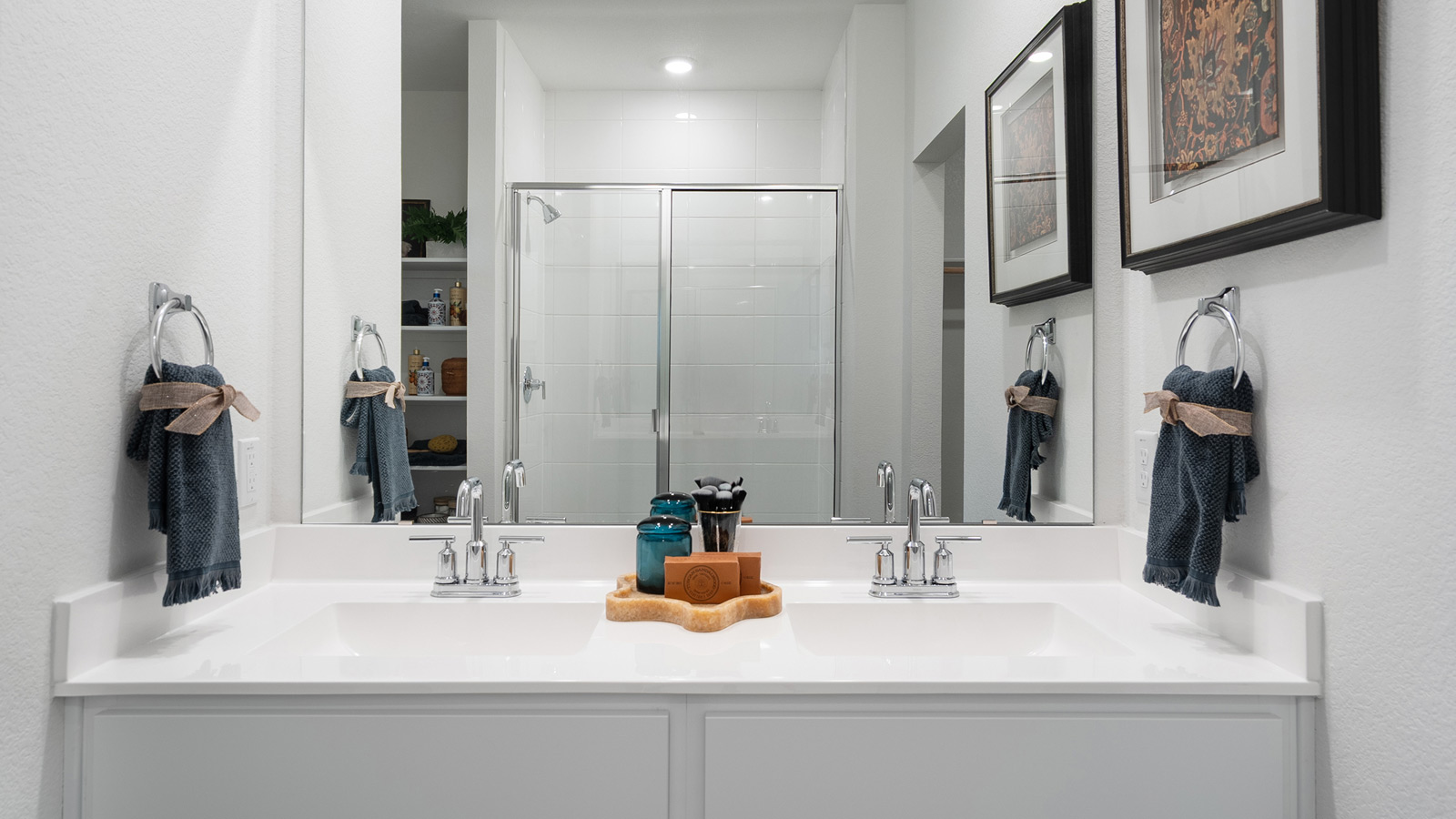Bathroom with dual sinks and a large mirror