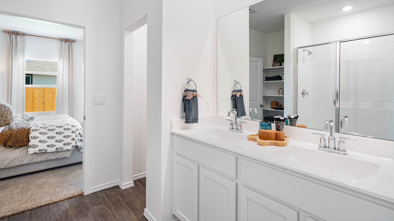 Bathroom with dual sinks and a large mirror